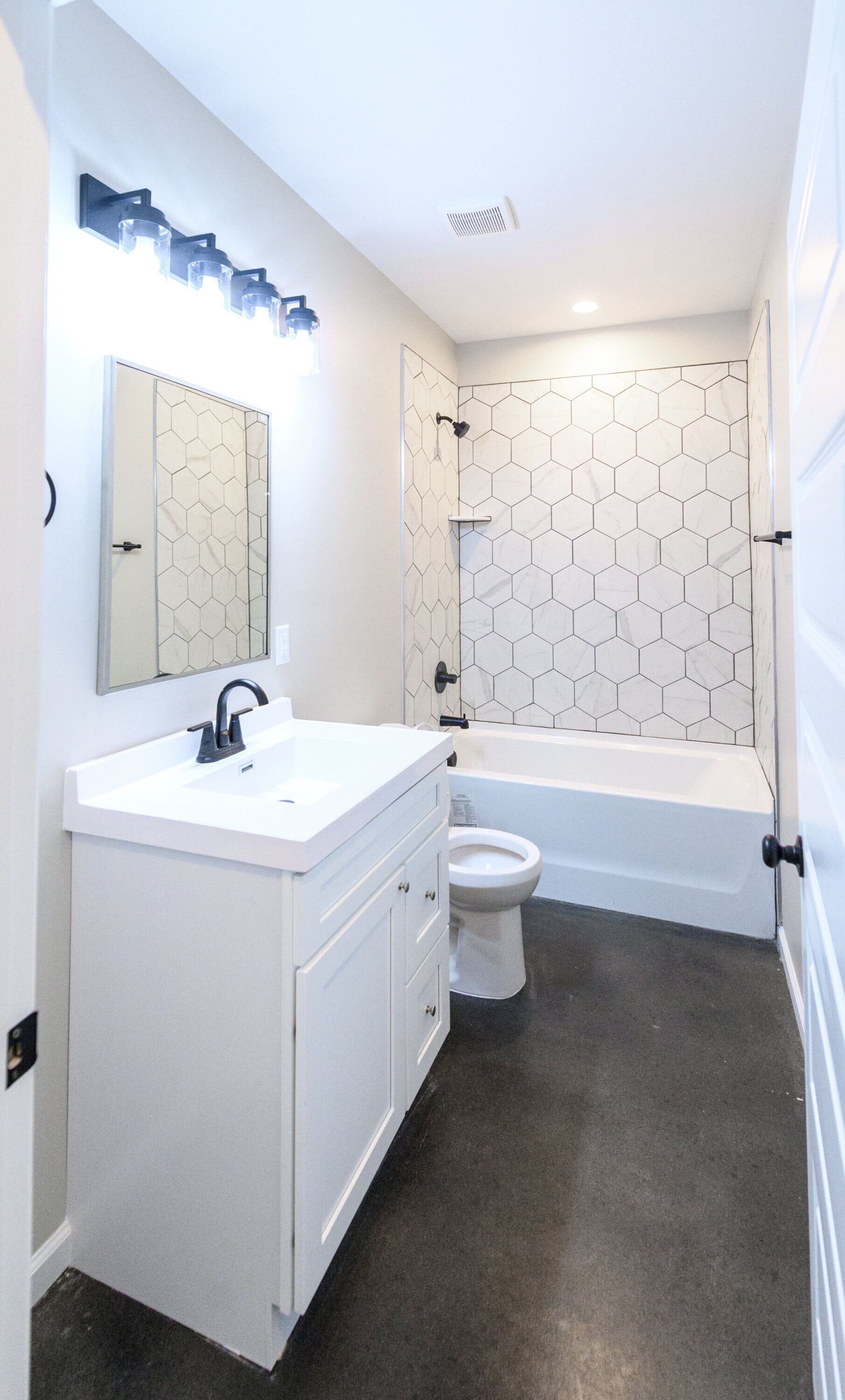 Second bathroom with a white vanity and tub